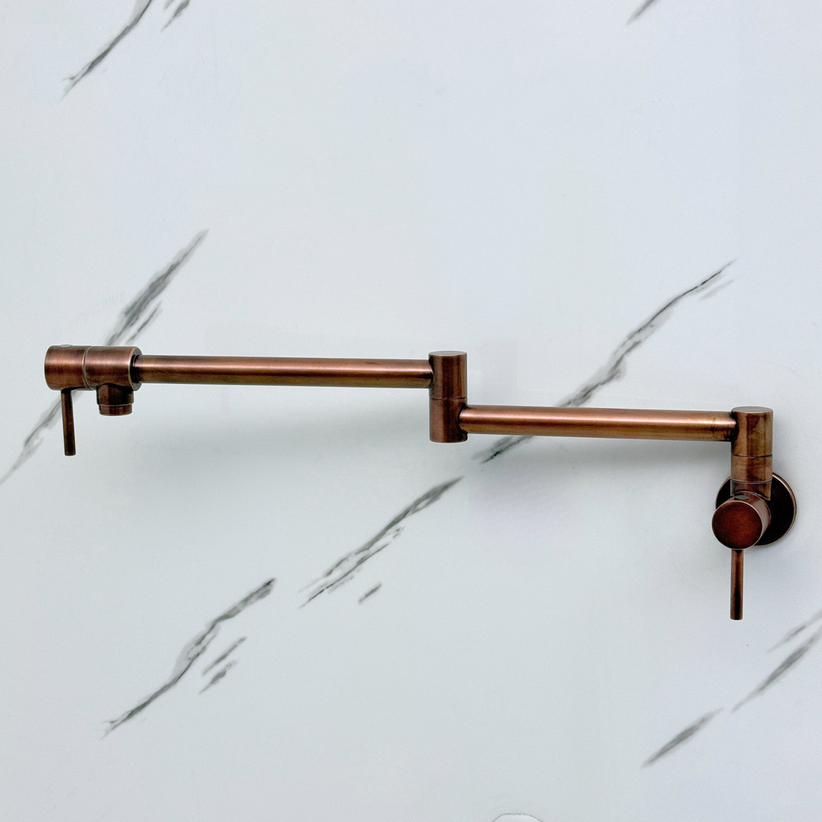 Side view of antique copper wall-mount pot filler