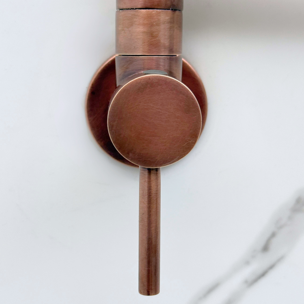 Antique copper pot filler shown folded against wall