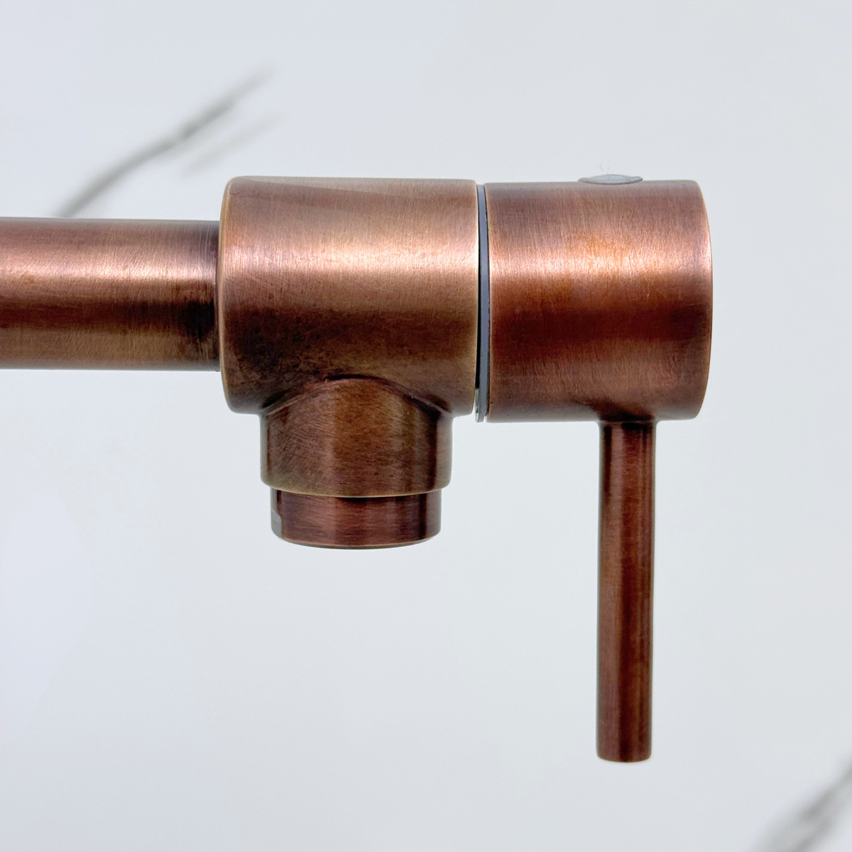 Double-jointed swing arm detail on antique copper pot filler