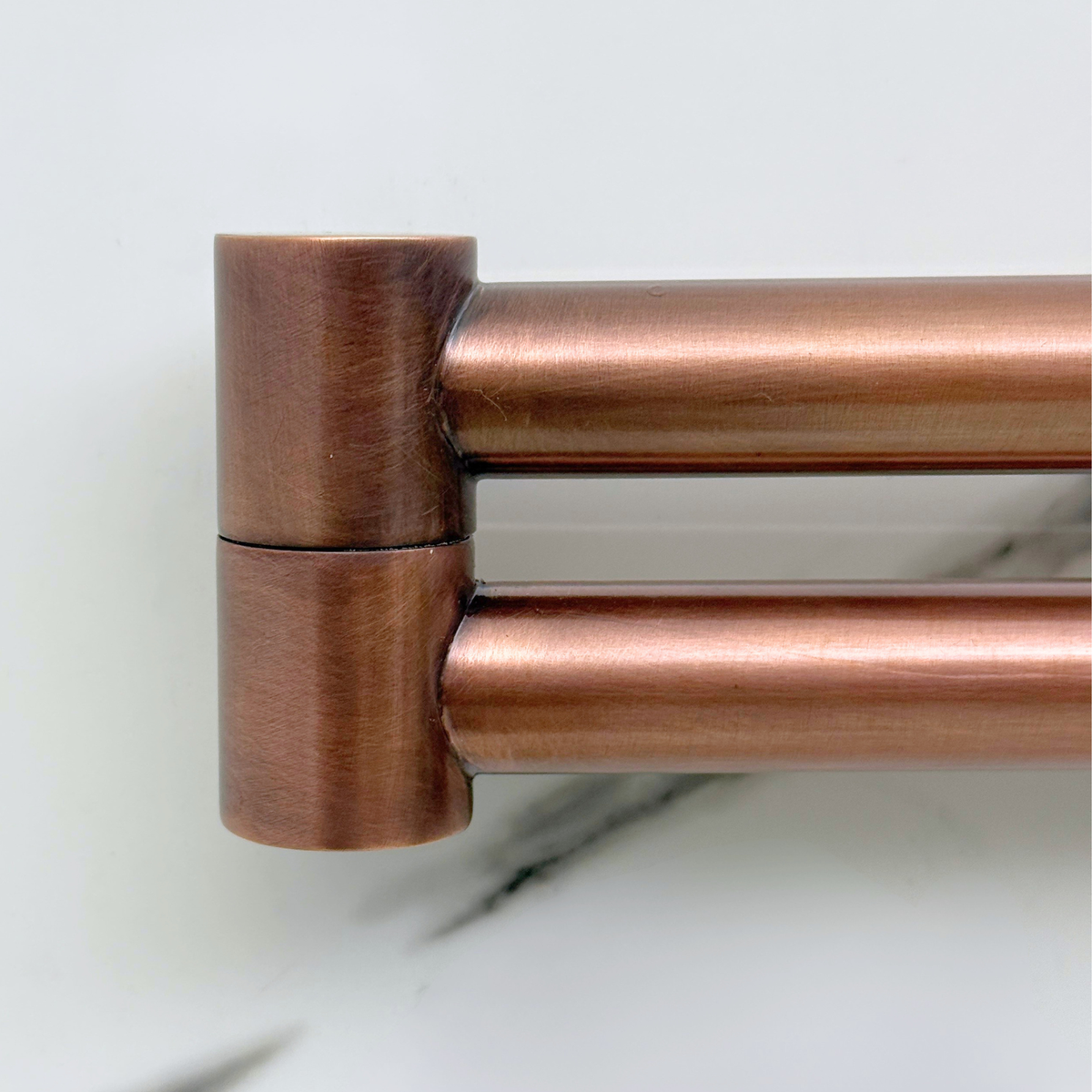 Antique copper finish detail on wall-mount pot filler