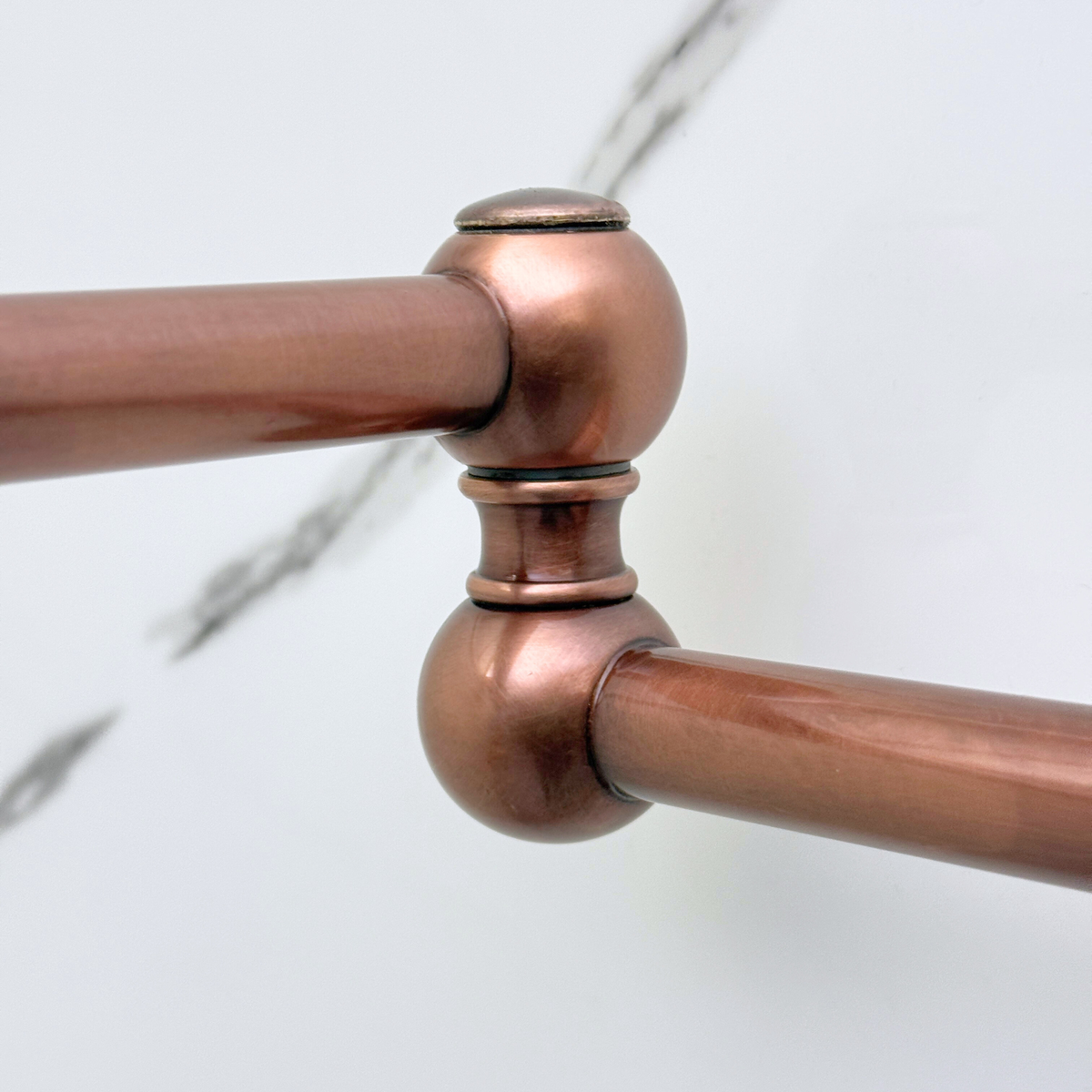 Cross handle detail on antique copper pot filler