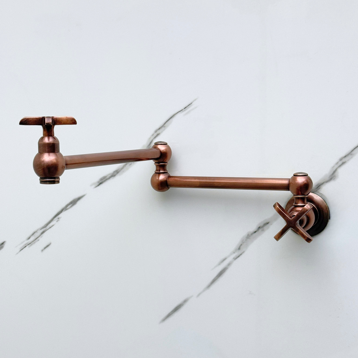 Antique copper finish detail on cross-handle pot filler