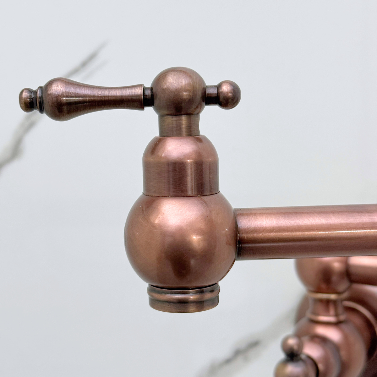 Double-jointed arm detail on antique copper pot filler