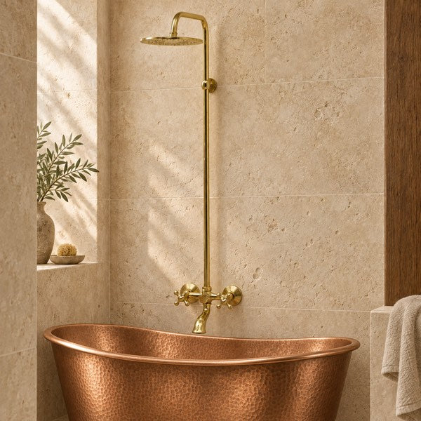 Vintaless exposed brass shower system with a tub filler installed above a bathtub